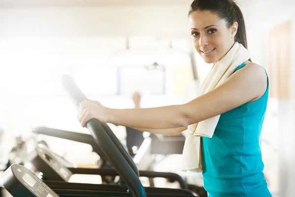Attractive woman doing cardio exercise at gym