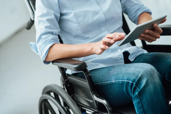 Woman in wheelchair using a tablet