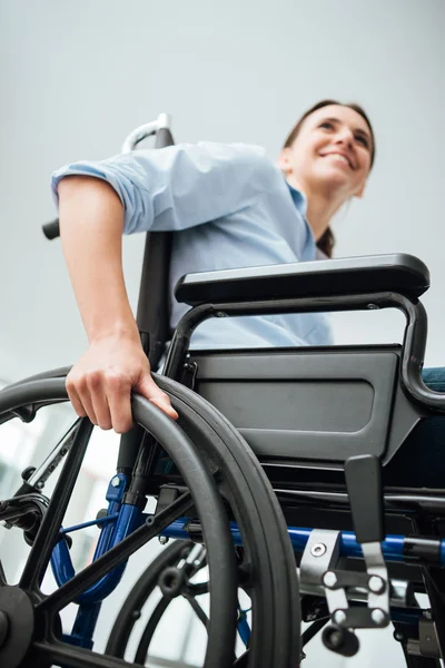 Smiling young woman in wheelchair