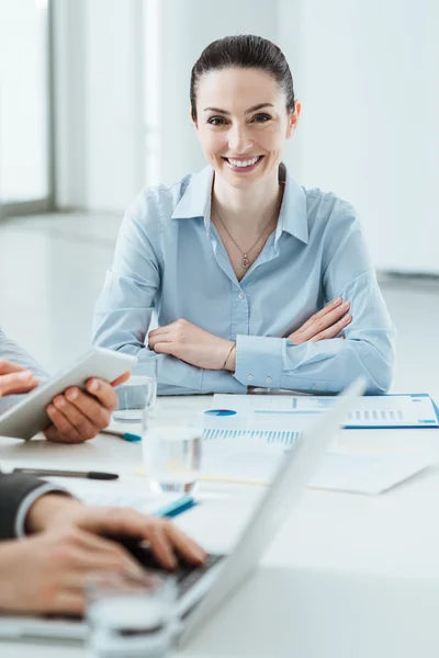 Business team at work and female executive smiling