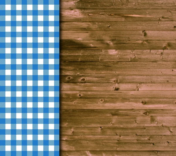 Traditional wooden background with blue white tablecloth