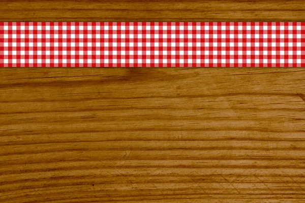 Wooden vintage background withred white tablecloth