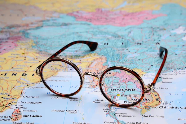Glasses on a map of Asia - Bangkok