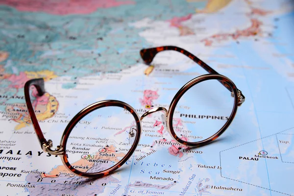 Glasses on a map of Asia - Brunei