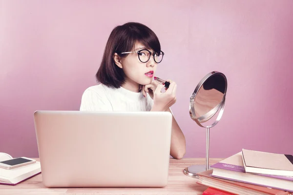 Young asian women make up with workspace table