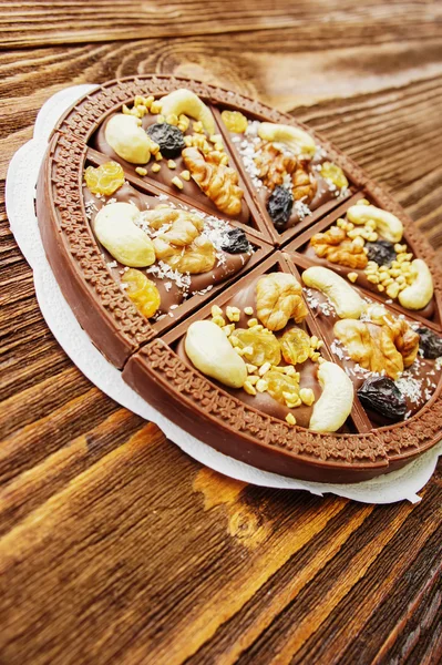 Dessert chocolate pizza with raisins and nuts