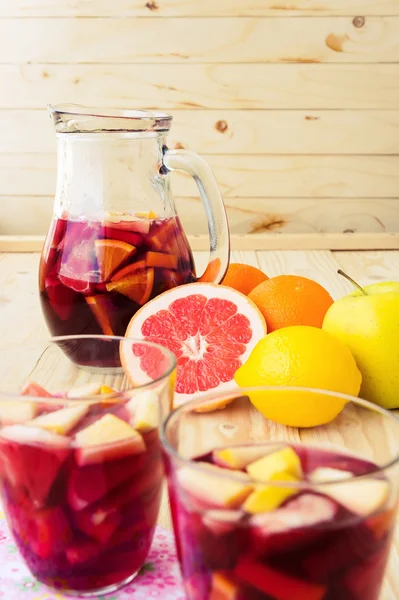 Jug of homemade delicious red sangria with limes oranges, apples