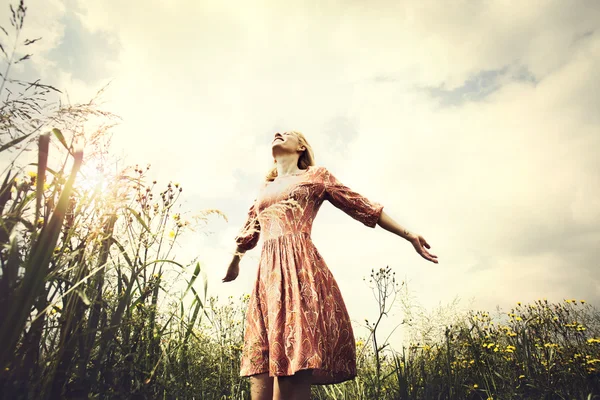 Beautiful woman taking a deep breath at the sunset