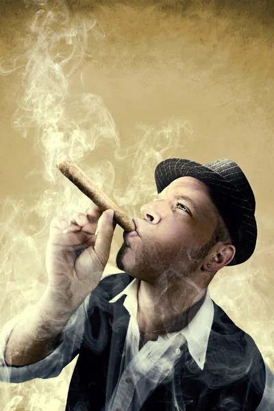 Man smoking a big cigar surrounded by smoke