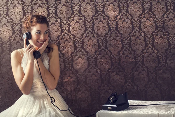 Beautiful young woman on the phone in livingroom in her English