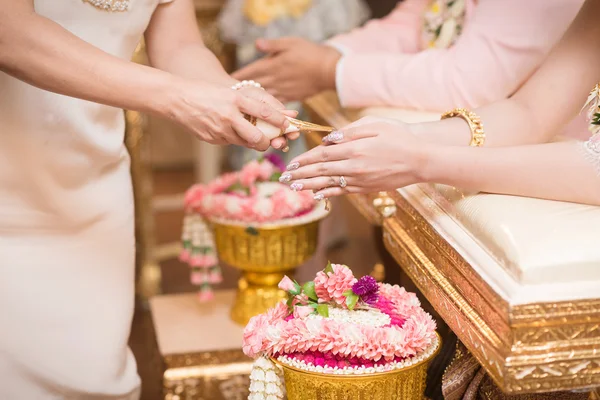 Hands pouring blessing water into bride\'s bands, Thai wedding