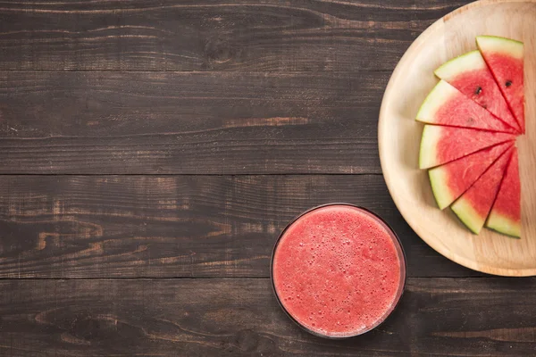 Healthy watermelon smoothie on a wood background with a lot of c