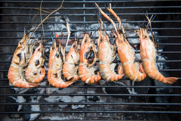 Grilled shrimps on the flaming grill, barbecue seafood