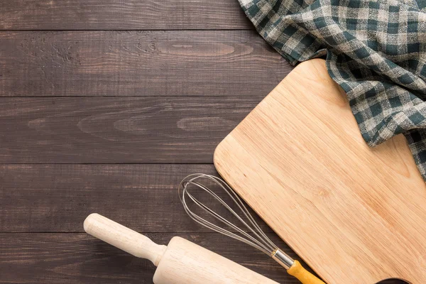 Wooden kitchen tools and napkin on the wooden background