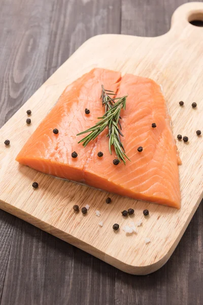 Fresh salmon with pepper on the wooden table