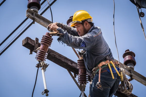 Electrician working on the electricity pole