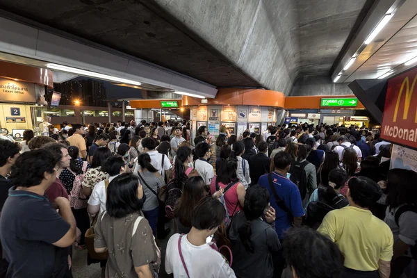 Crowd of people in rush hour at BTS public train station at night