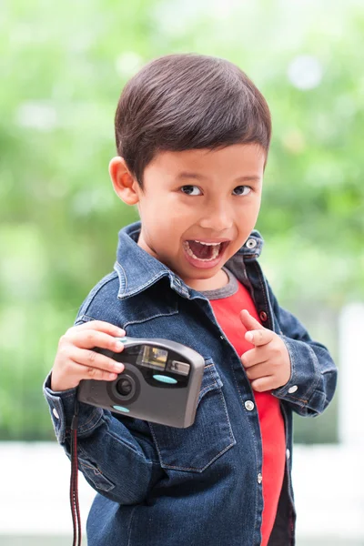 Asian boy with compact camera.