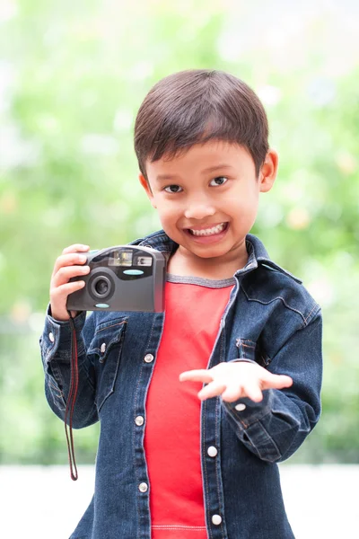 Asian boy with compact camera.