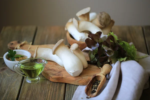 White mushroom (king trumpet mushrom, oyster) on a wooden board