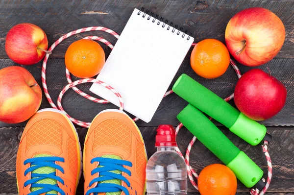 Sports shoes, jumping rope, apple, citrus, bottle of water and o