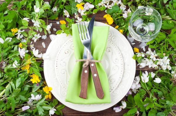 Summer table settings with flowers, cutlery and wineglass. Floral wedding table settings in rustic style. Holidays background