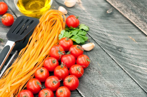 Cherry tomatoes, pasta, olive oil, garlic, herbs and pasta tongs