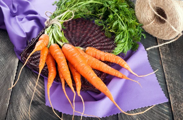 Fresh organic carrots on a wooden table