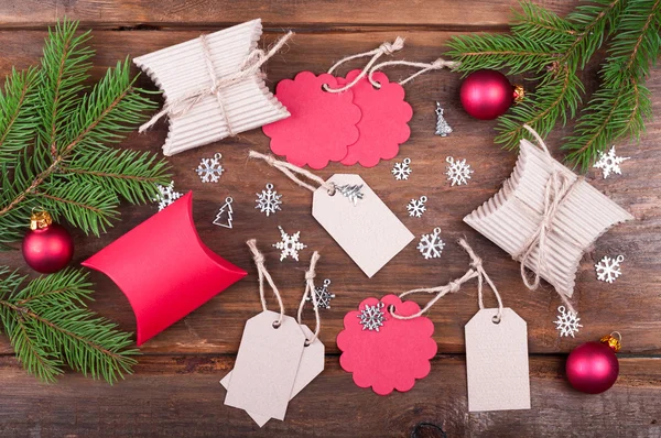 Handmade christmas gift tags and christmas gift boxes on wooden