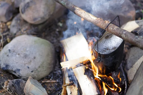 Preparing food on campfire