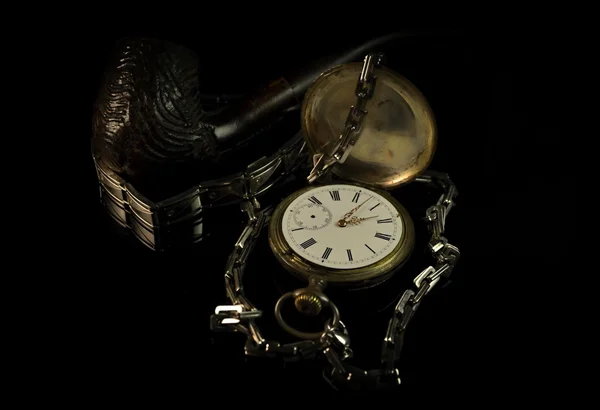 Old watch and pipe and kerosene lamp