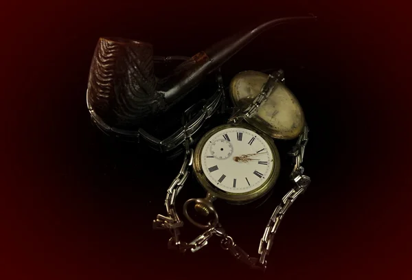 Old watch and pipe and kerosene lamp