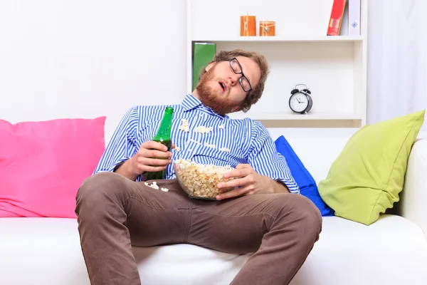 Sleeping at a party with popcorn and beer