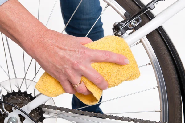 Spring cleaning of the bike frame with a cloth