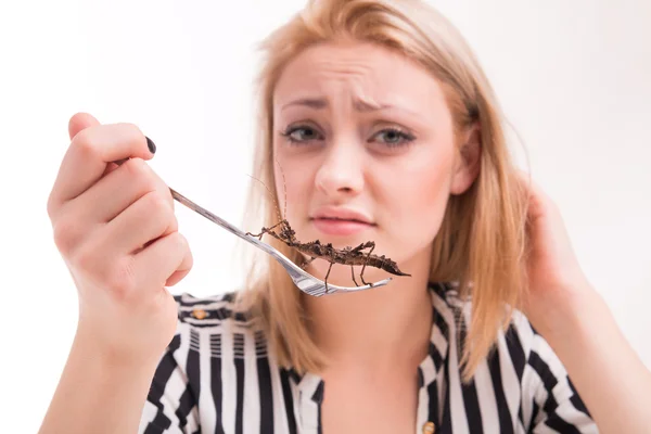 Disgusted woman eating insects