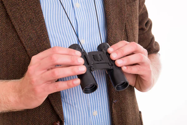 Man holding small binoculars