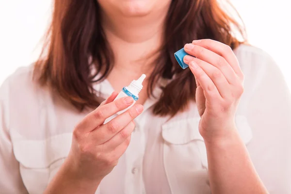 Woman opening eye drops