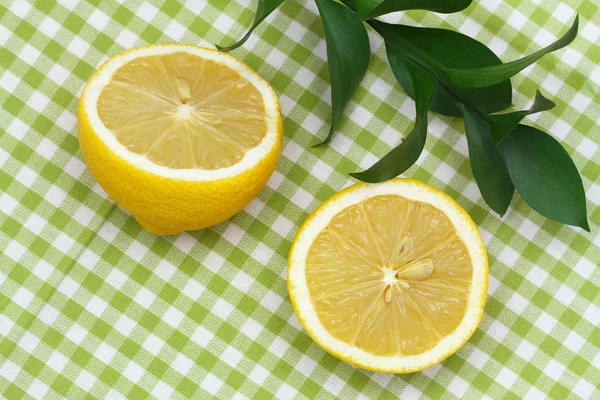 Lemon halves on green checkered cloth