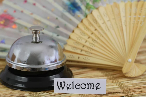 Welcome card with hotel bell and fan