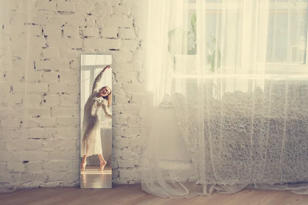 Woman in white dress dancing