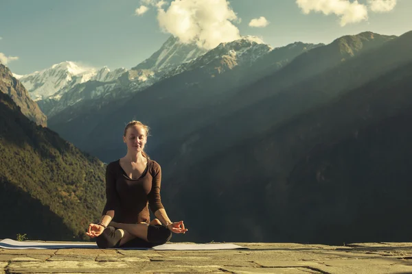Young Female doing yoga meditation outdoor