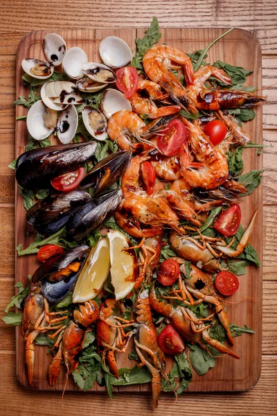 Fresh mussels, crayfish, shrimp decorated with arugula, tomatoes