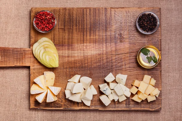 Cheese platter garnished with honey, apple and spice