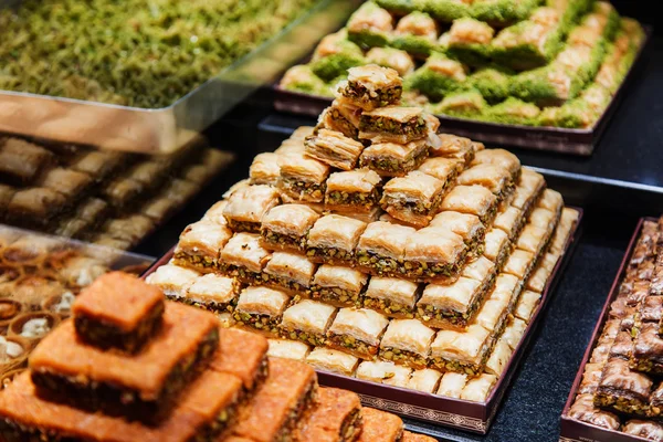 Eastern sweets in a wide range, baklava, Turkish delight with almond, cashew and pistachio nuts on plates