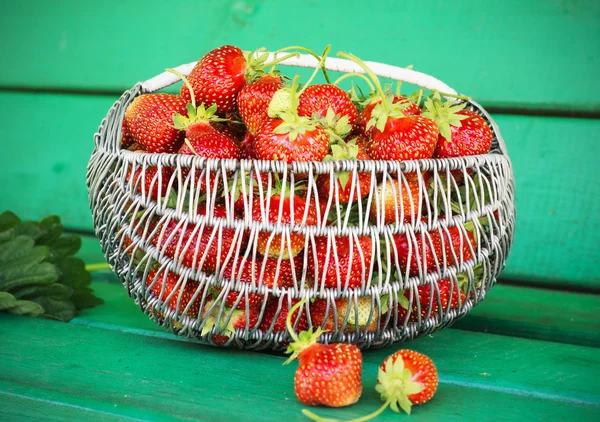 Ripe and tasty strawberries metal a basket in the street