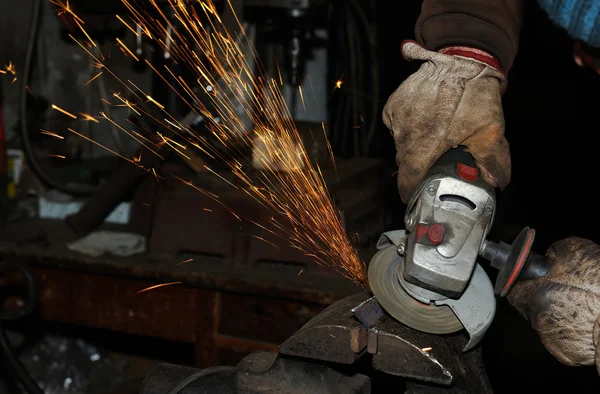 Angle grinder cutting steel with sparks