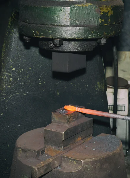 Blacksmith hammering hot iron