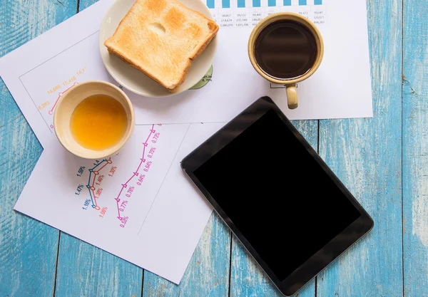Black display Tablet , Toast , Honey , Coffee cup , Graph data a