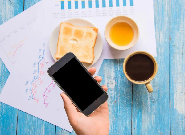 Black display Smart phone in hand , Toast , Honey , Coffee cup ,