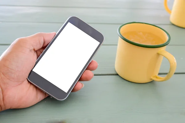 White display Smart phone in hand,Glass of water made from zinc